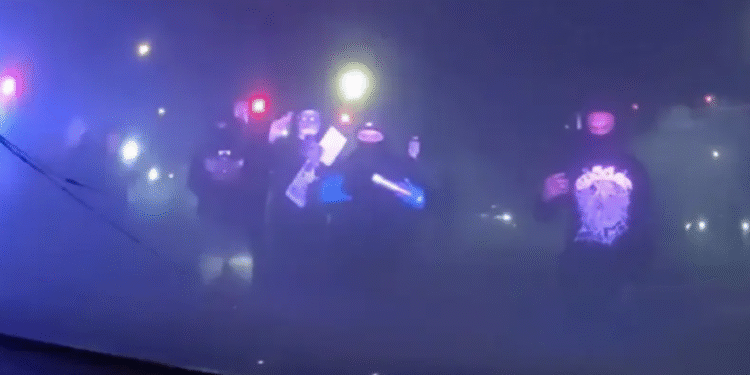 Masked Individuals Surround Patrol Car With Police Inside